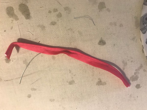 wire inserted partway into piping