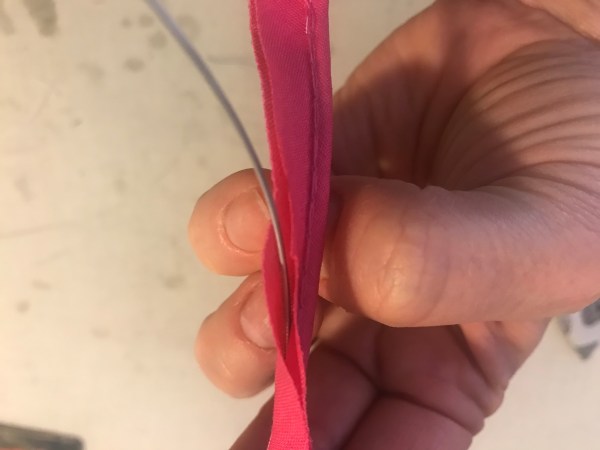 wire inserted between the stitches of the piping